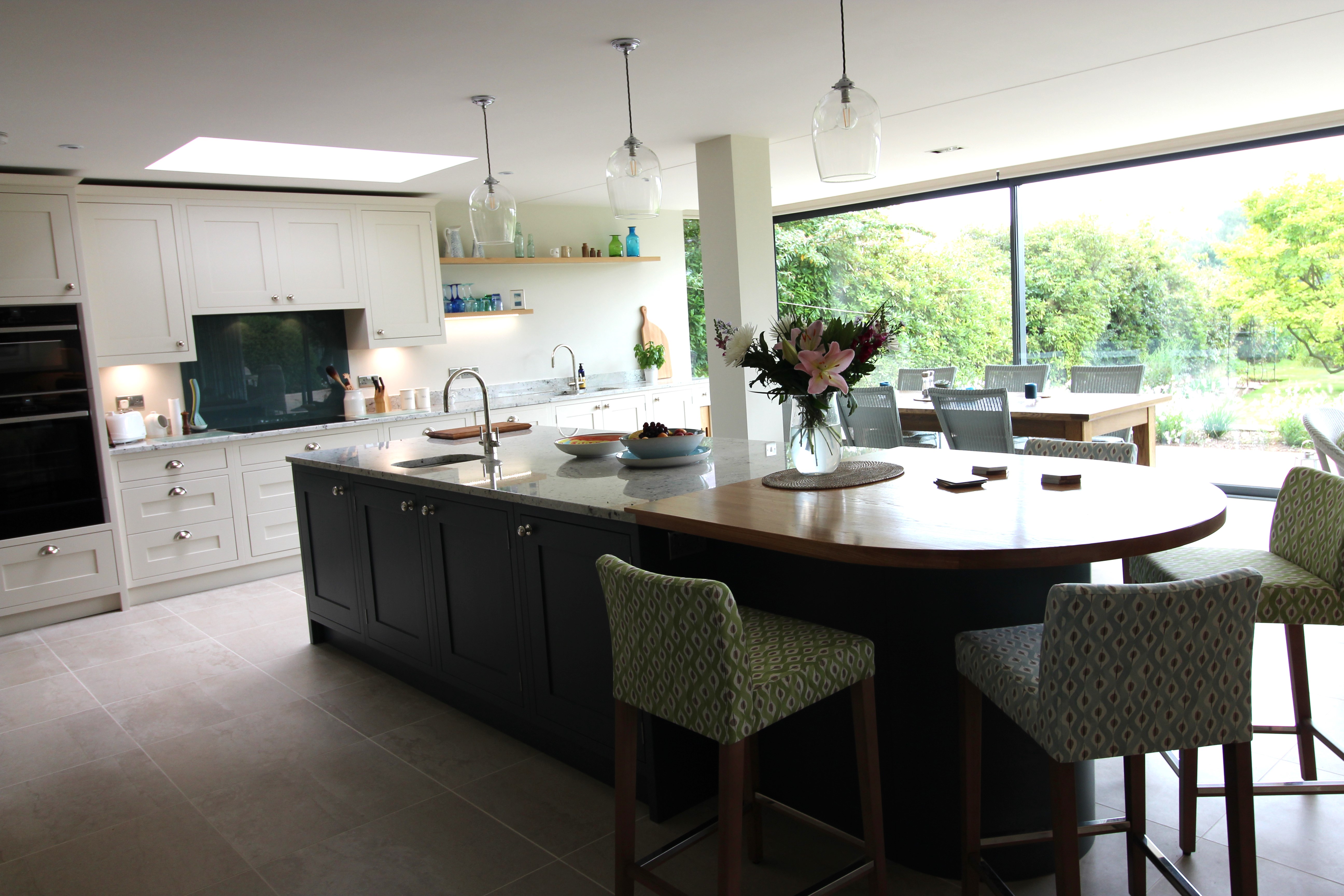 A dual surface for the island worktop creates a stunning breakfast bar in this classic Shaker kitchen.